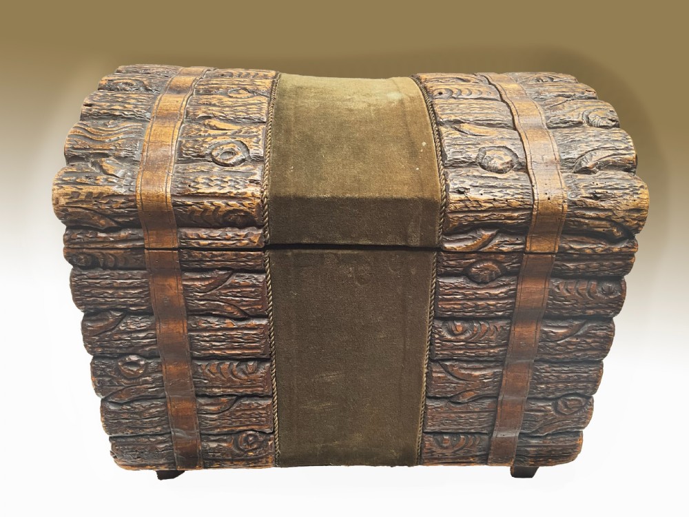 A dome-topped carved wooden box featuring a faux log bark texture with a central olive green velvet band.