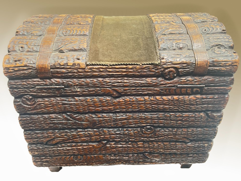 A dome-topped carved wooden box featuring a faux log bark texture with a central olive green velvet band. View VI