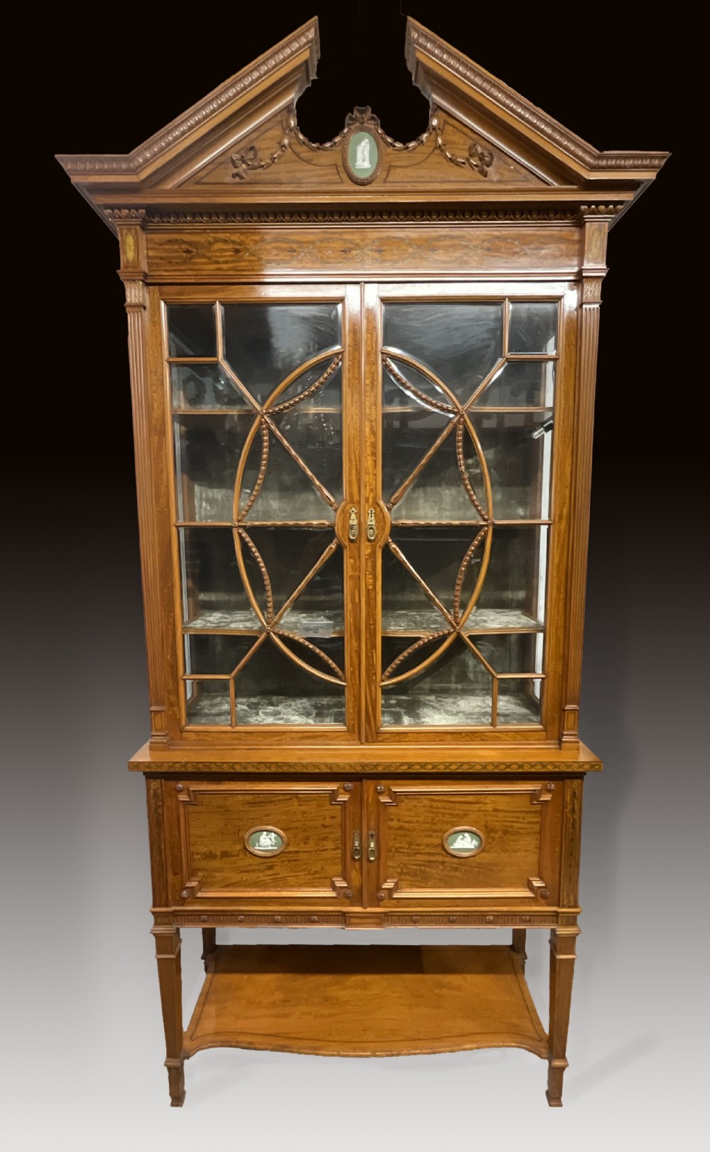 An exhibition quality satin wood and porcelain mounted cabinet with gold key.