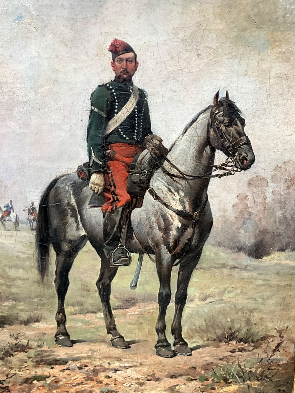 A nineteenth-century oil painting depicting a uniformed French cavalry officer seated atop a grey horse in a open landscape setting.