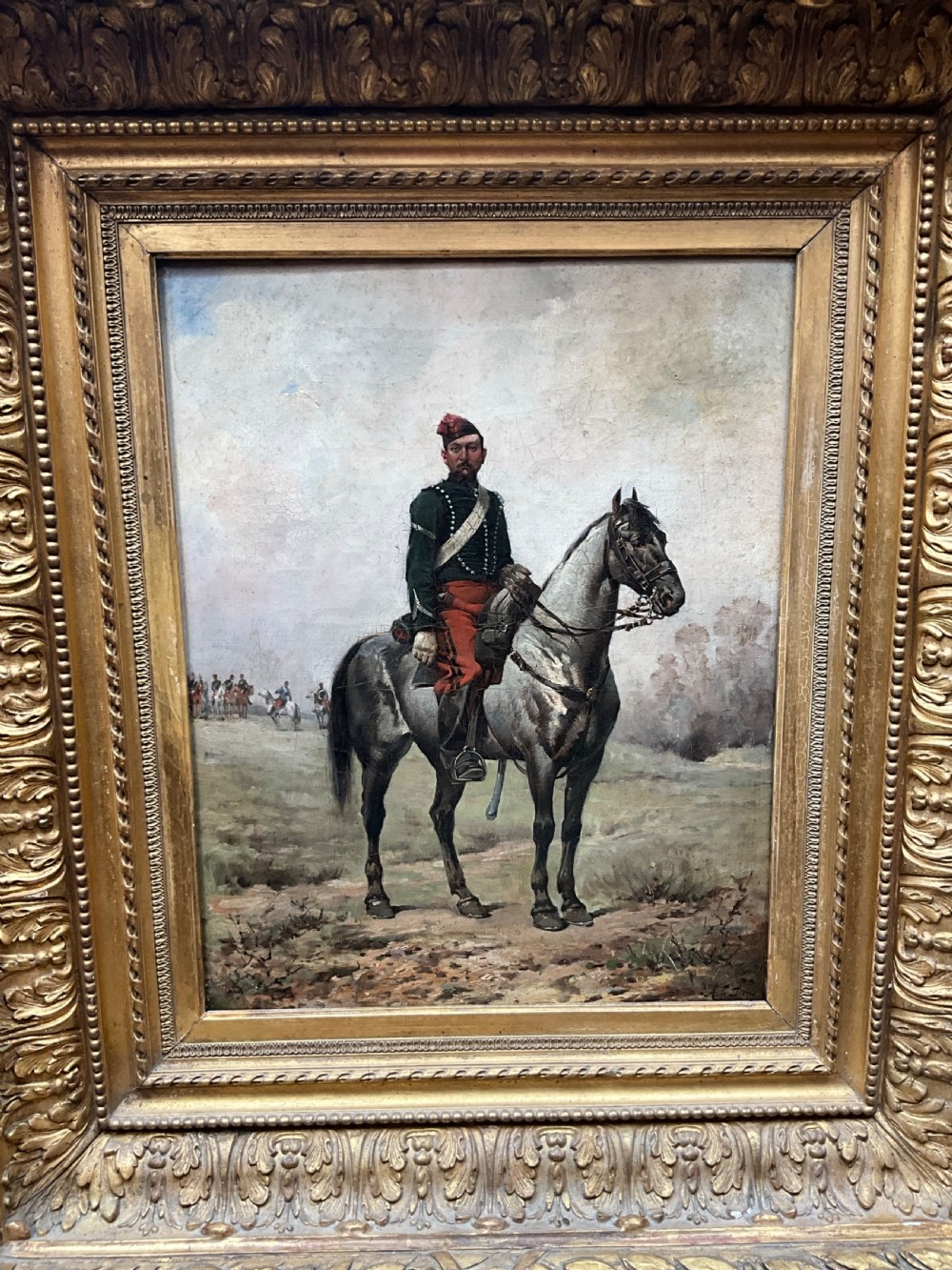 A nineteenth-century oil painting depicting a uniformed French cavalry officer seated atop a grey horse in a open landscape setting. View II