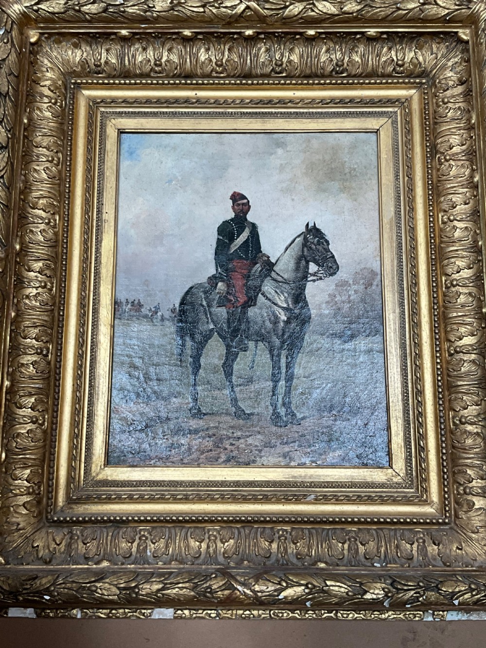 A nineteenth-century oil painting depicting a uniformed French cavalry officer seated atop a grey horse in a open landscape setting. View IX