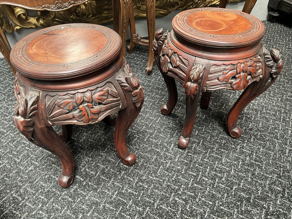 A pair of large round blue and white Japanese porcelain jardinieres decorated with avian motifs resting on intricately carved hardwood stands. View VI