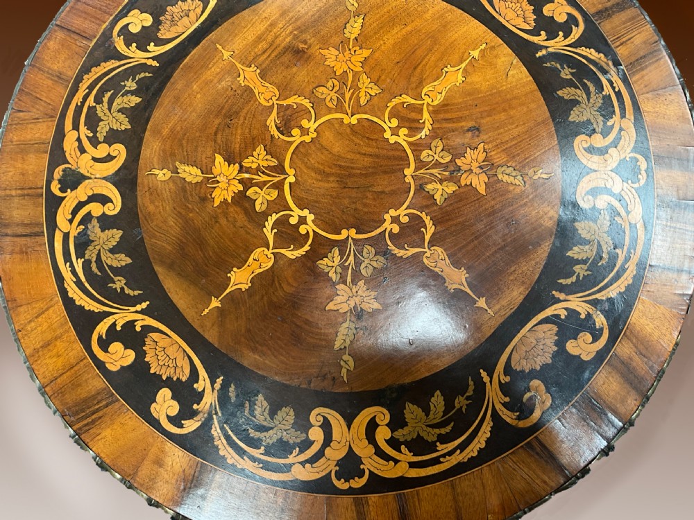 A Victorian circular walnut wine table featuring floral marquetry wood inlay on the top, a spiral-carved central column, and a tripod base with brass accents. View II