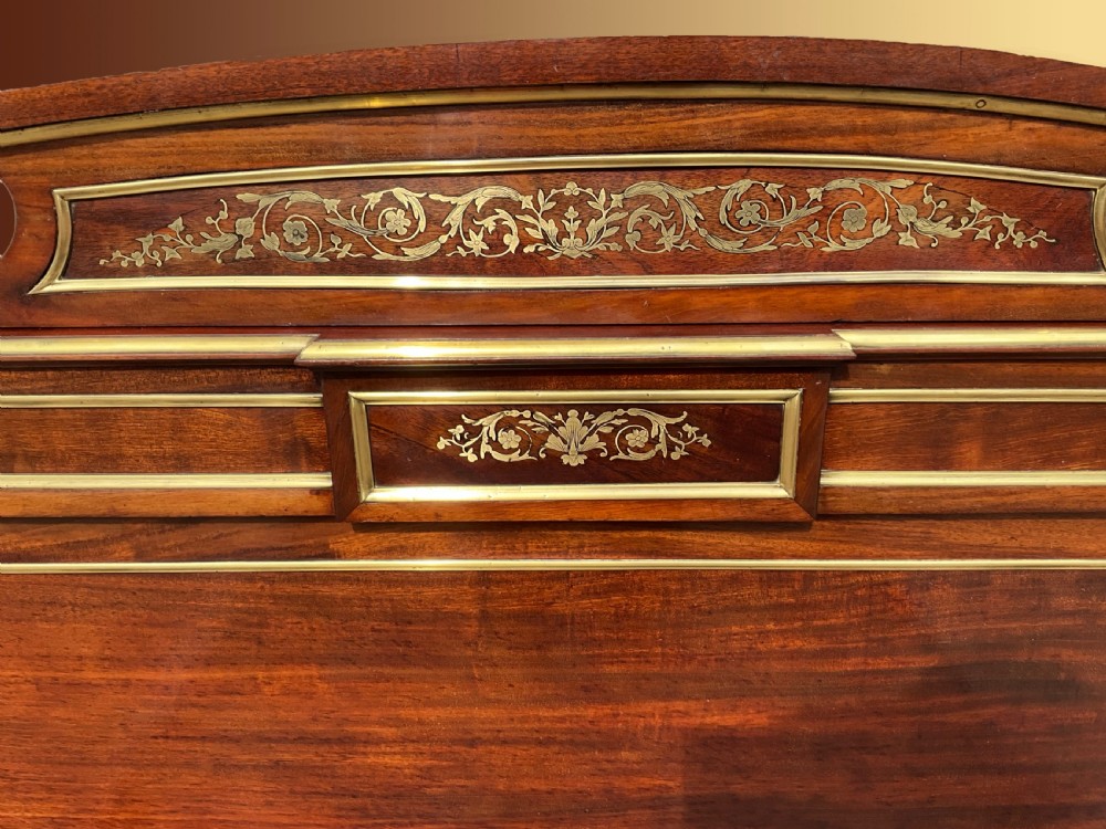 A mahogany and brass French Empire style bed. View IV