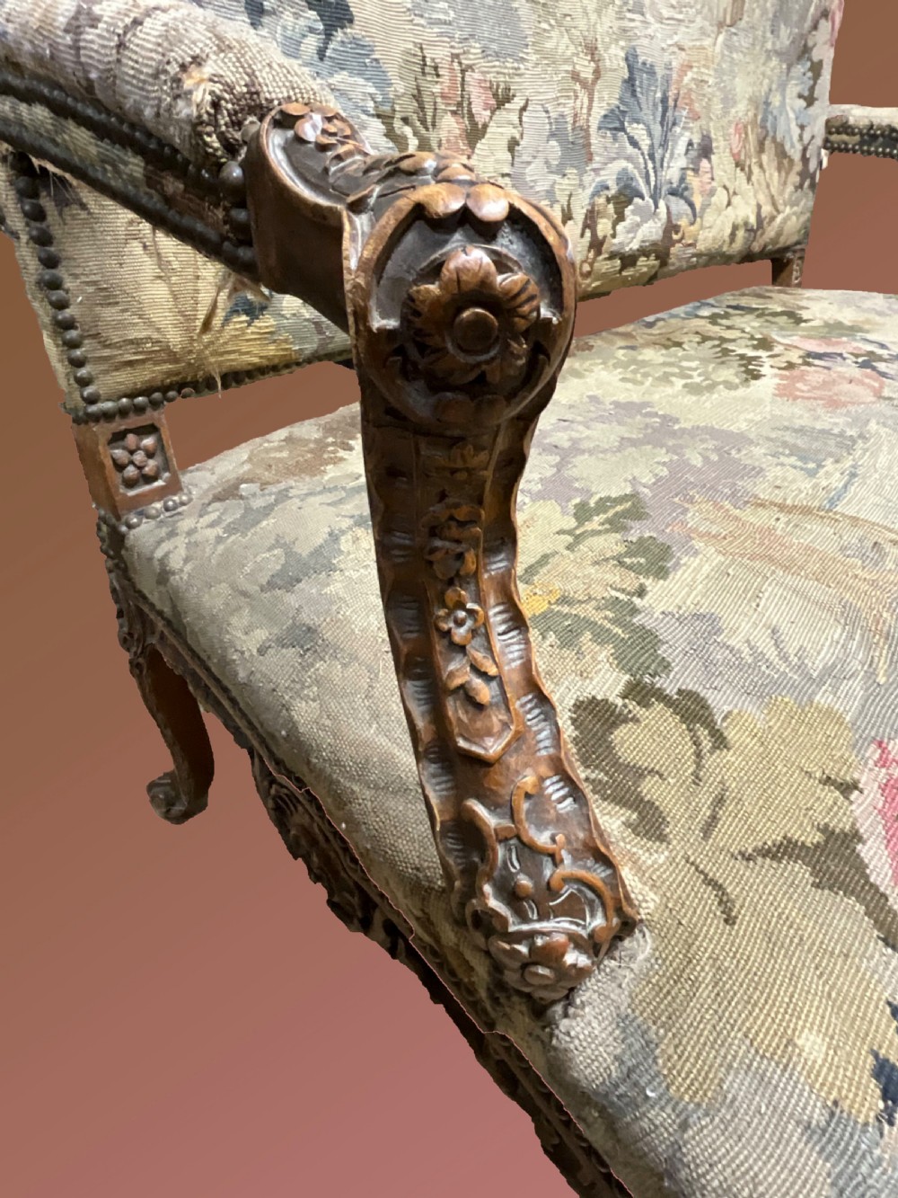 An 18th-century French carved wooden settee upholstered in a historic landscape and floral tapestry. View IV