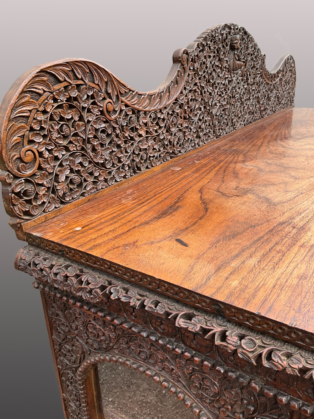 A heavily carved Burmese glazed breakfront library bookcase View III