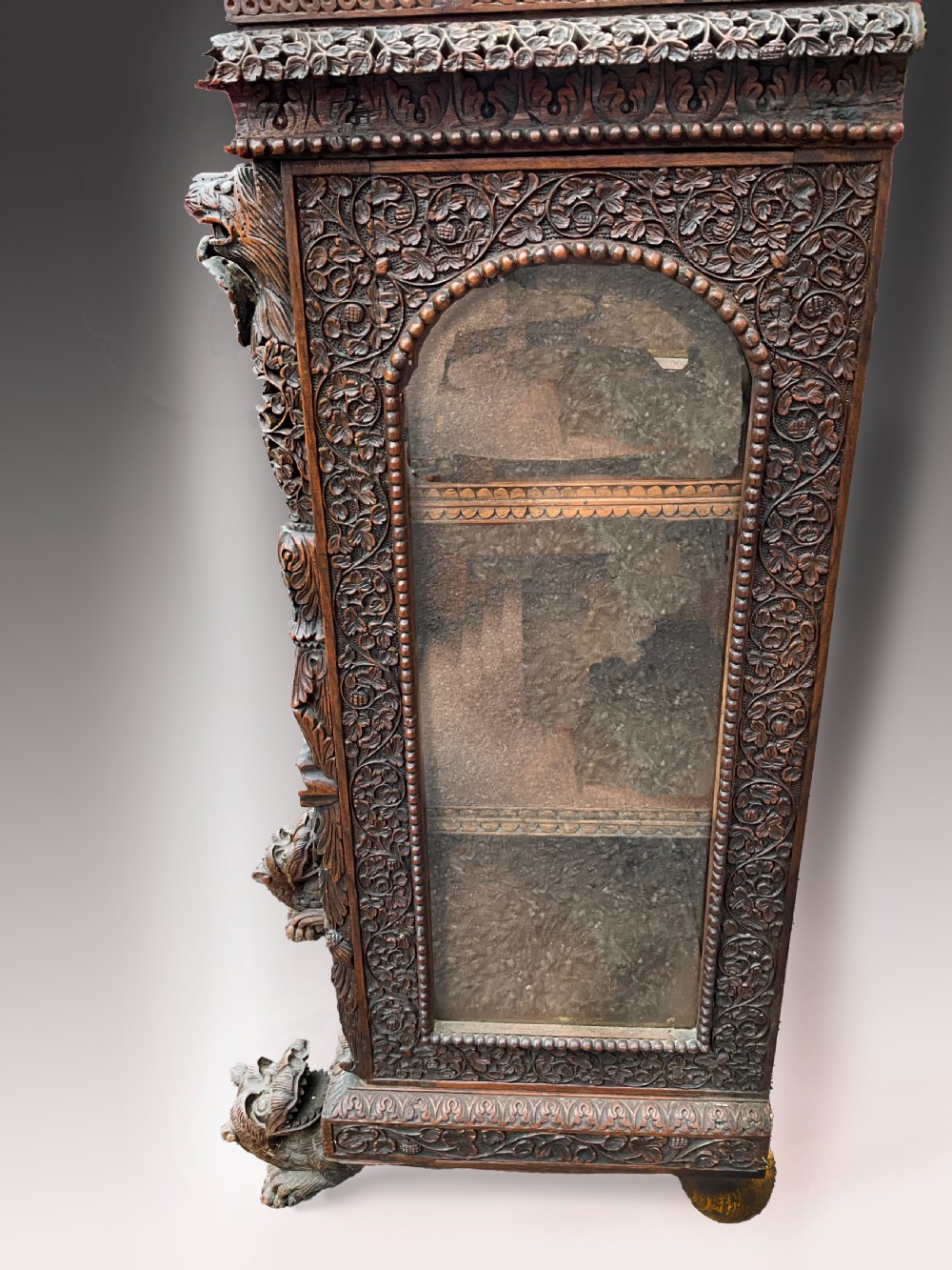 A heavily carved Burmese glazed breakfront library bookcase View IV