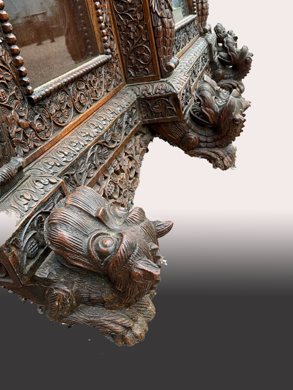 A heavily carved Burmese glazed breakfront library bookcase View VI
