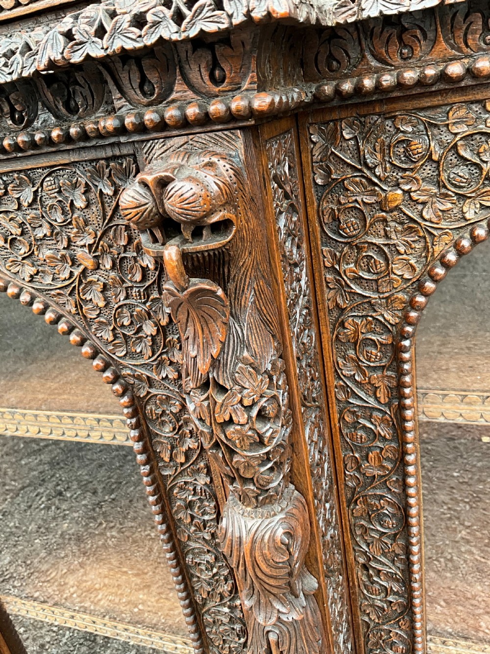 A heavily carved Burmese glazed breakfront library bookcase View VIII