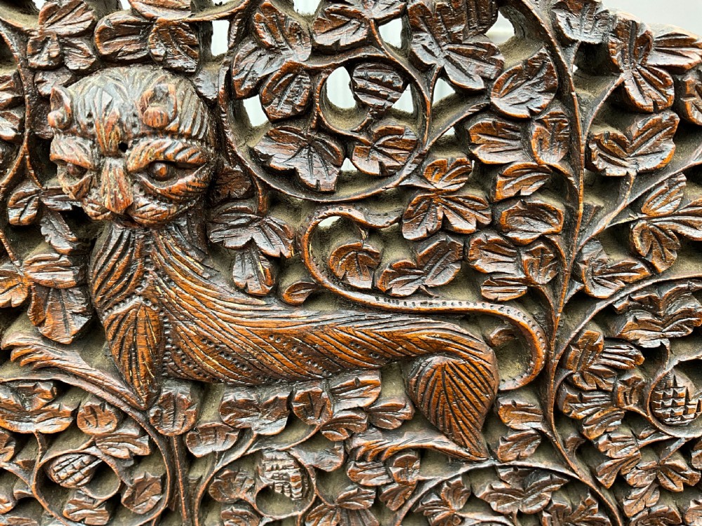 A heavily carved Burmese glazed breakfront library bookcase View IX