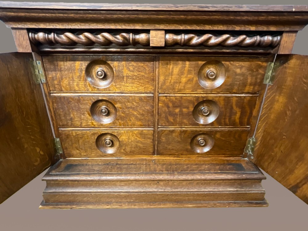 A small two door oak cabinet. Circa 1900.  View II