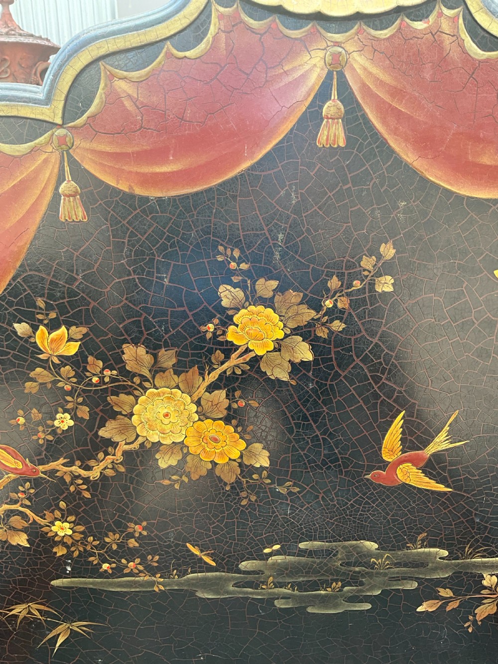 A pair of black lacquered single bed frames decorated with gold painted East Asian landscape scenes, figures, and shaped pagoda headboards. View III