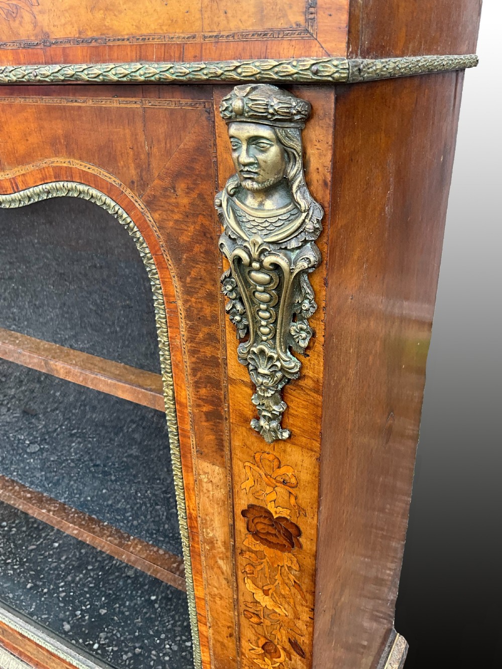 A Victorian burr walnut glazed cabinet featuring floral marquetry inlays, metal mounts, and a single glass door. View II