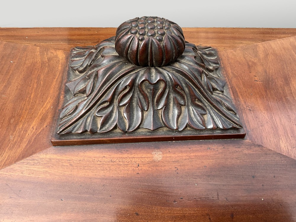 A Georgian mahogany sarcophagus wine cooler featuring a stepped lid with a carved acanthus finial and resting on four carved lion paw feet. View III