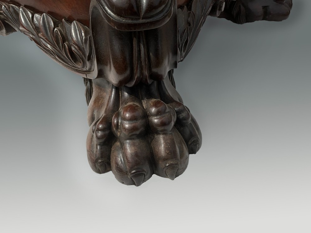 A Georgian mahogany sarcophagus wine cooler featuring a stepped lid with a carved acanthus finial and resting on four carved lion paw feet. View IV