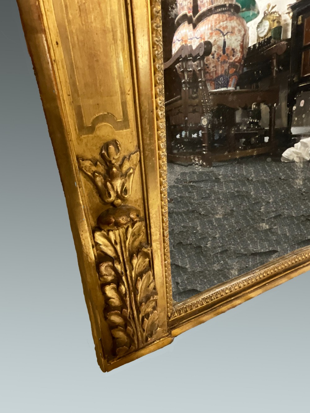 A large 19th-century French arched giltwood wall mirror with detailed wreath cresting and corner finials. View VII
