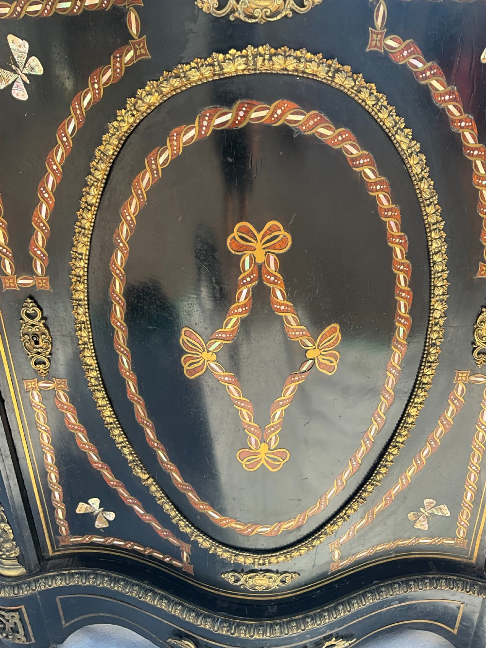 For sale is this French serpentine fronted, ebonised and inlaid marble topped side cabinet. c.1870. View VI