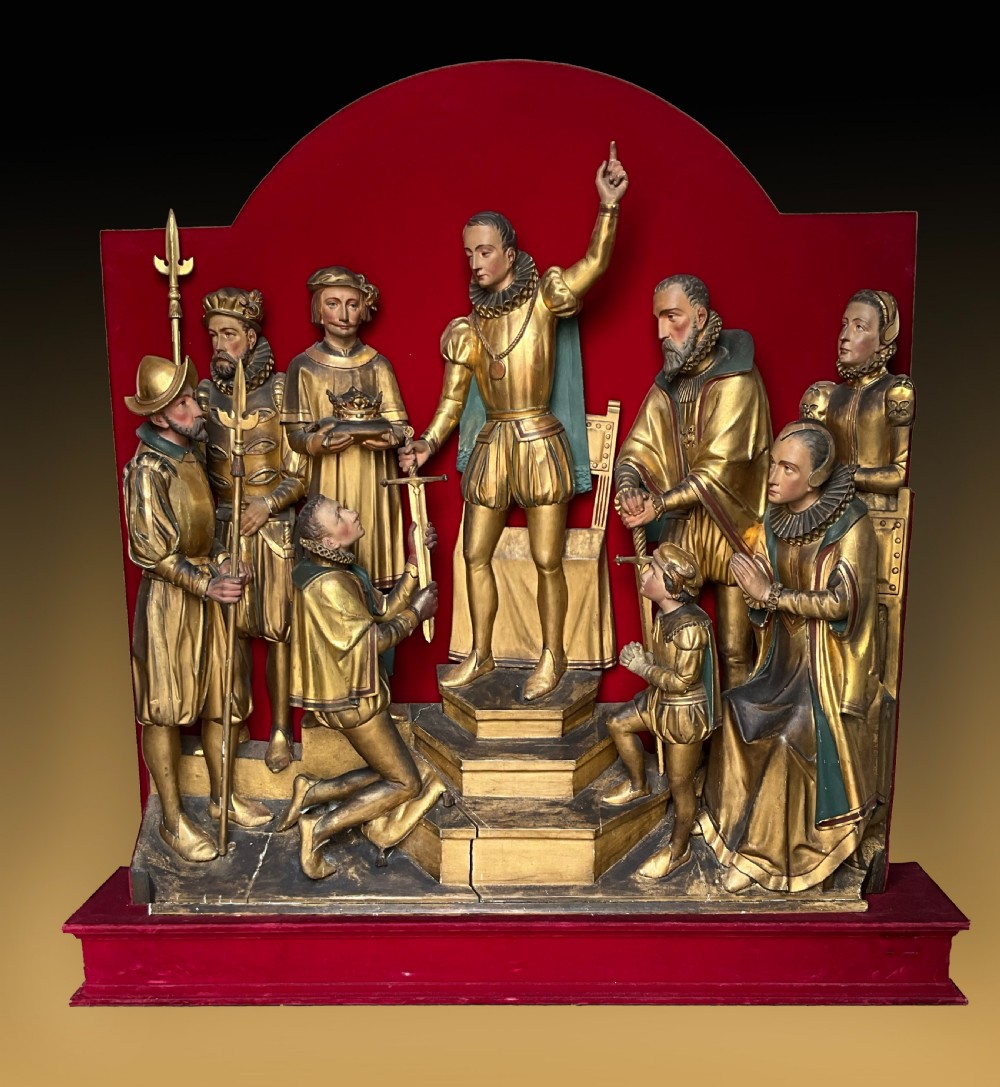 A mid-19th-century carved and gilded wooden figure group depicting multiple Renaissance figures against a red velvet backing.