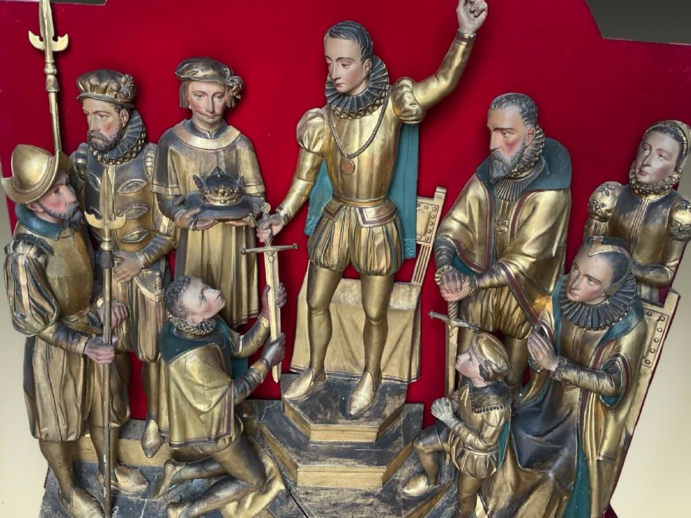 A mid-19th-century carved and gilded wooden figure group depicting multiple Renaissance figures against a red velvet backing. View II
