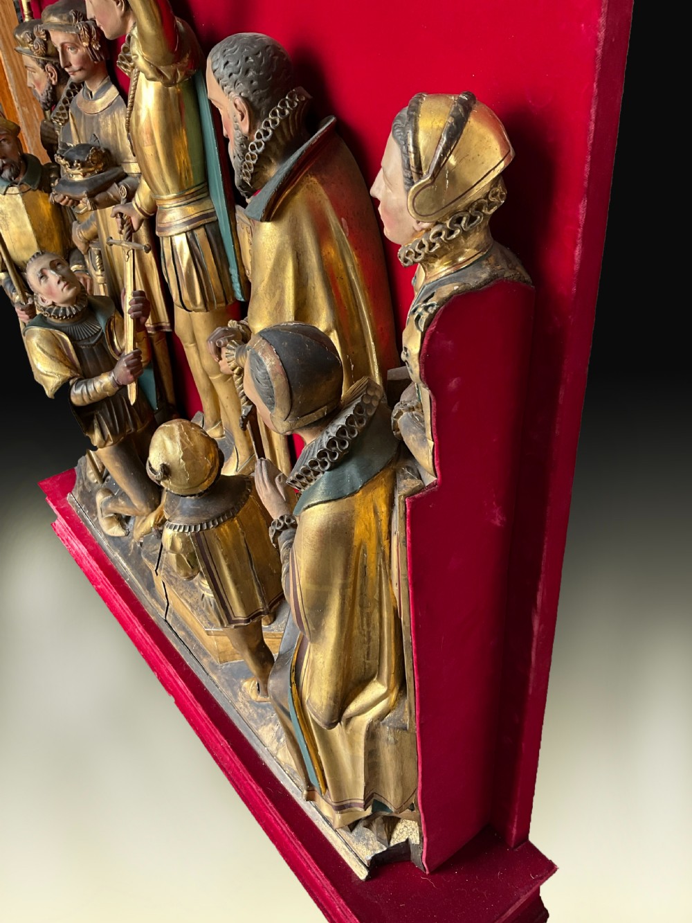 A mid-19th-century carved and gilded wooden figure group depicting multiple Renaissance figures against a red velvet backing. View III