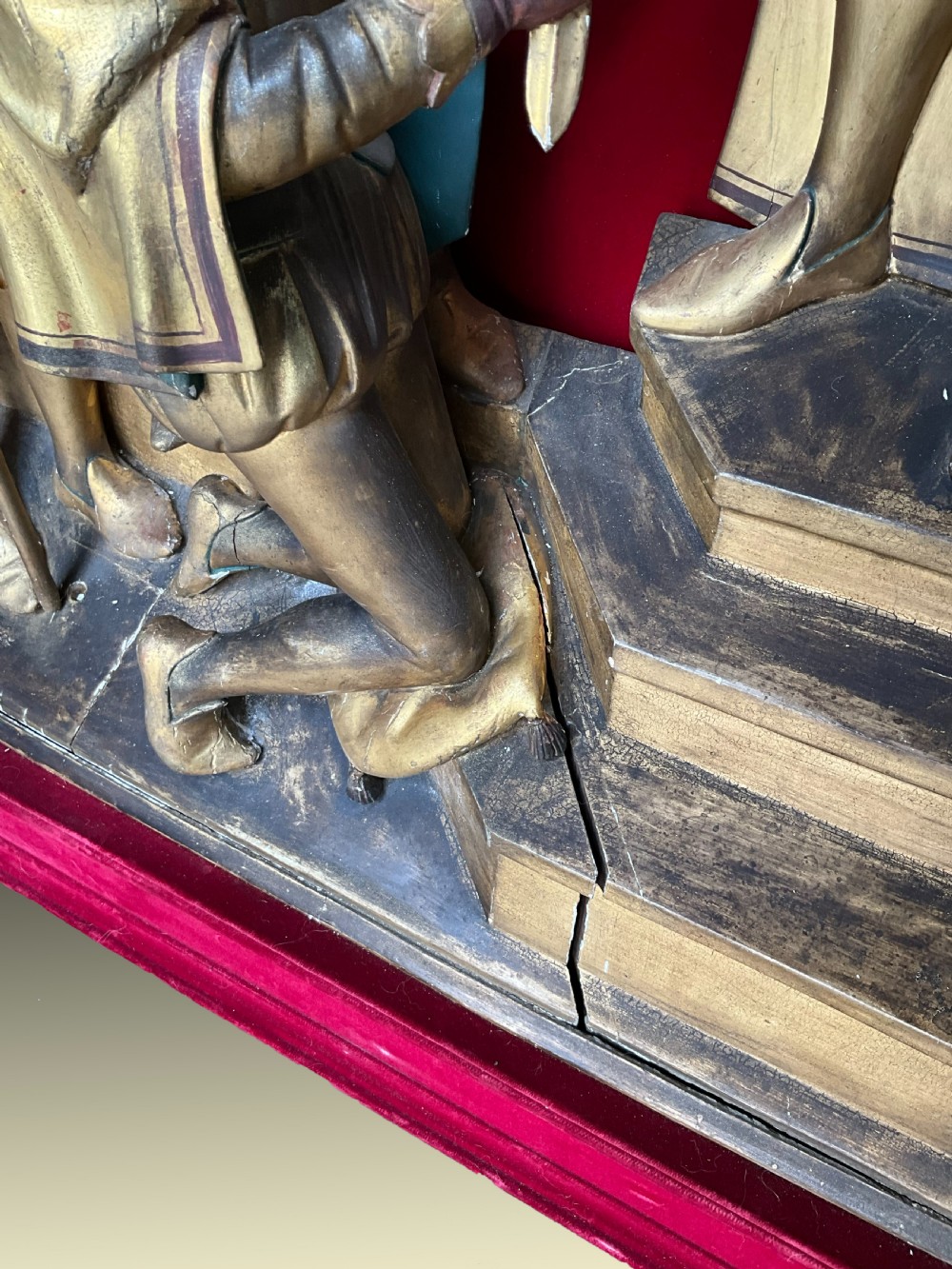 A mid-19th-century carved and gilded wooden figure group depicting multiple Renaissance figures against a red velvet backing. View V