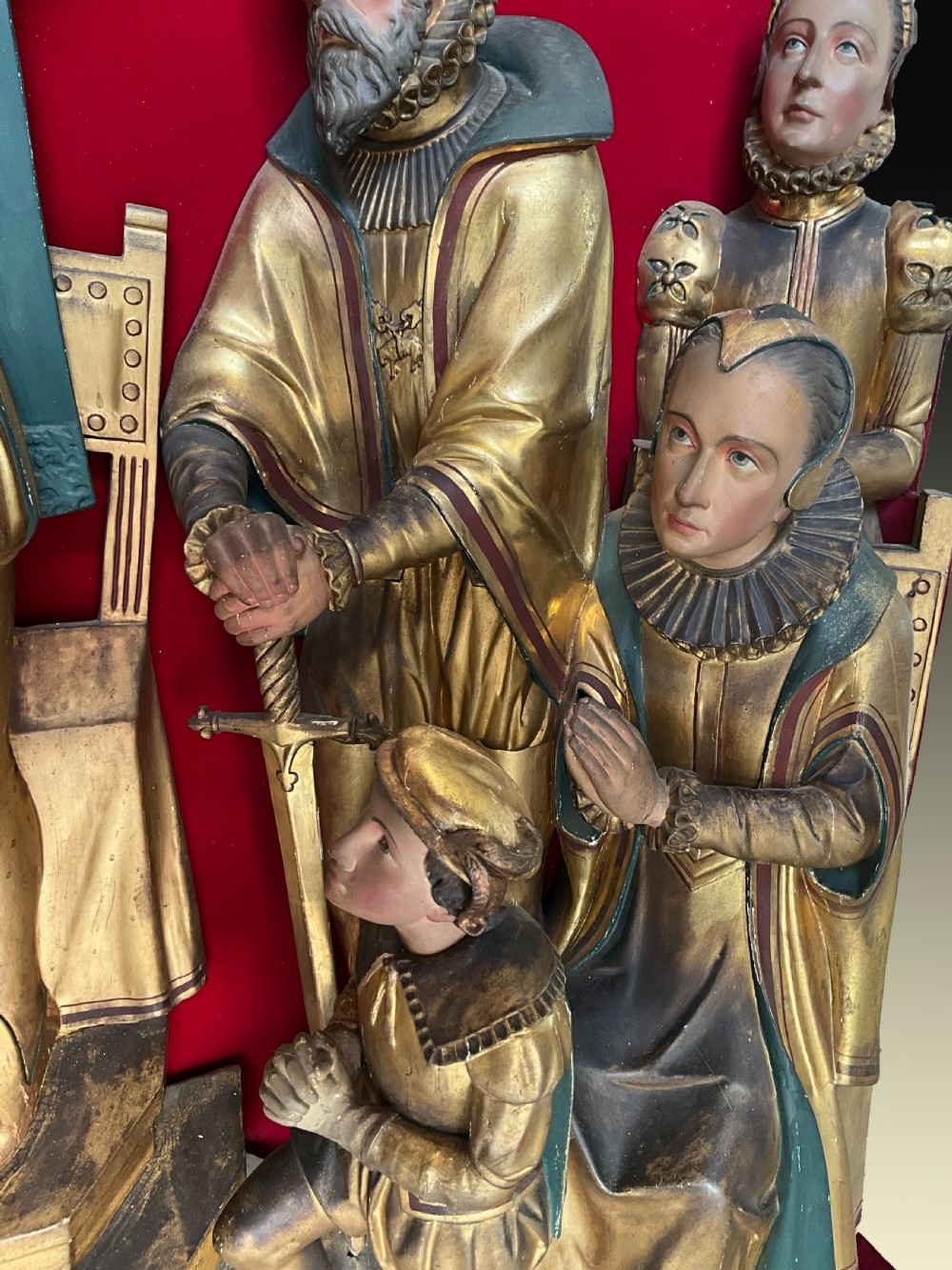 A mid-19th-century carved and gilded wooden figure group depicting multiple Renaissance figures against a red velvet backing. View VI