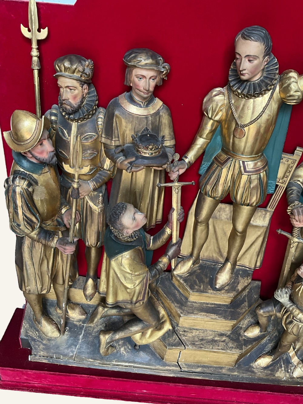 A mid-19th-century carved and gilded wooden figure group depicting multiple Renaissance figures against a red velvet backing. View IX