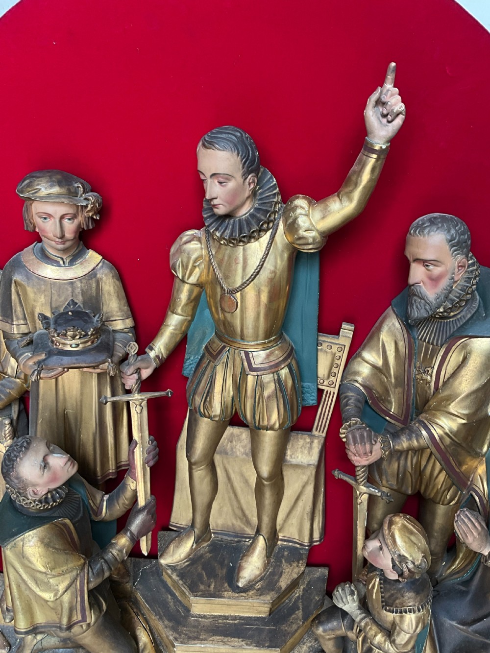 A mid-19th-century carved and gilded wooden figure group depicting multiple Renaissance figures against a red velvet backing. View X