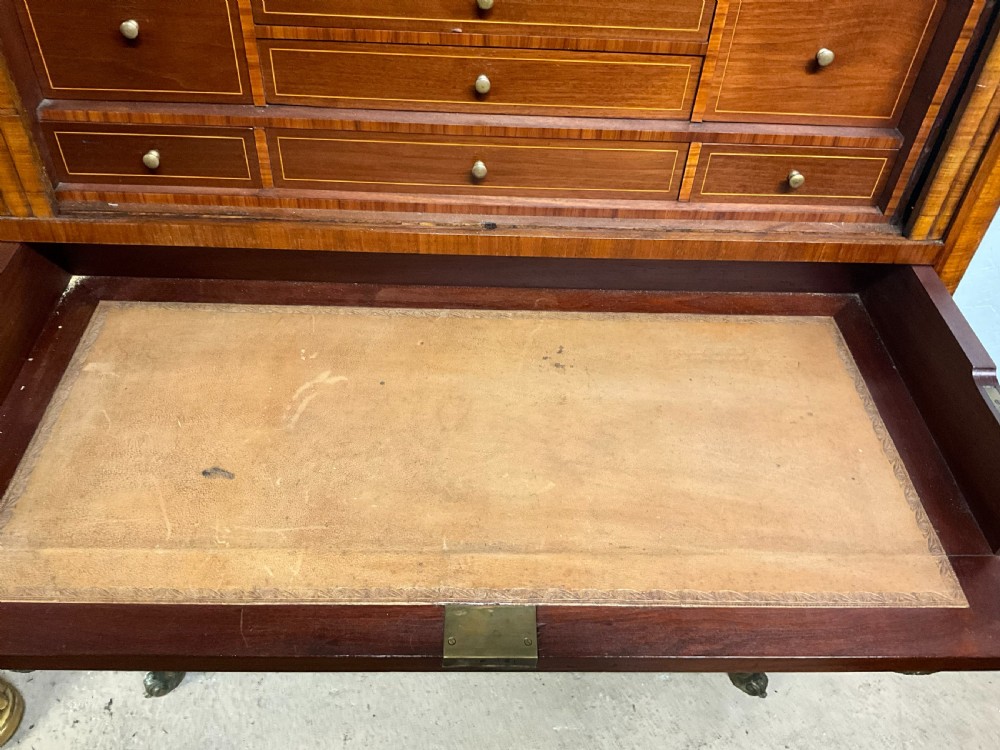 An antique French style marquetry writing cabinet featuring a marble top, tambour shutter front, middle drawer, floral inlaid doors, and brass mounts. View III