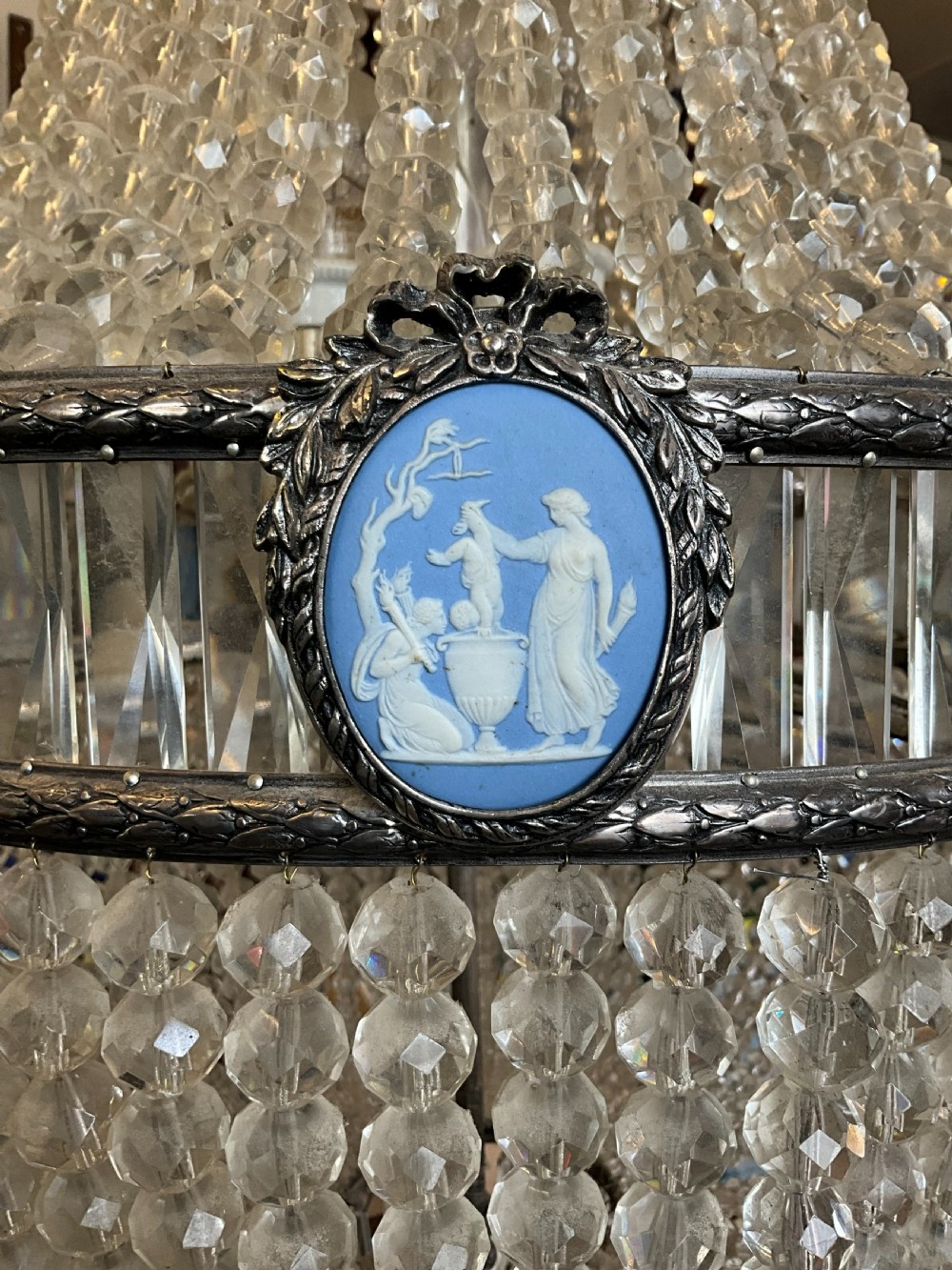 An antique crystal tent and bag chandelier featuring silvered metal bands inset with oval blue Wedgwood jasperware cameo plaques. View II