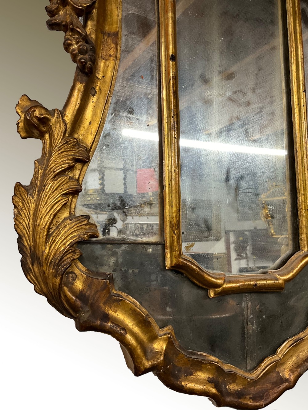 An 18th century continental gilt wood wall mirror View II