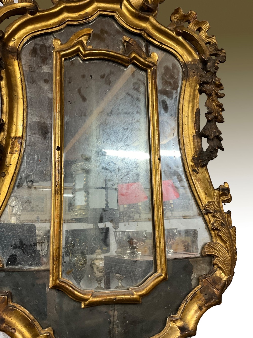 An 18th century continental gilt wood wall mirror View IX