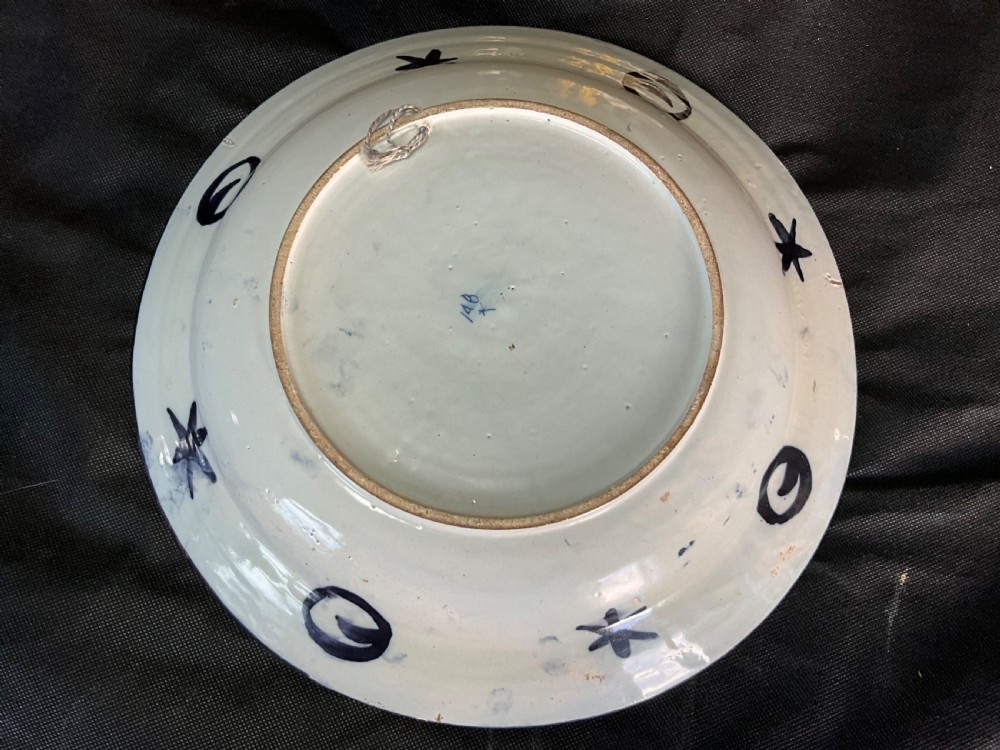 An 18th-century circular Delftware plate featuring hand-painted cobalt blue chinoiserie figures and floral panelled borders on a tin-glazed background. View VII