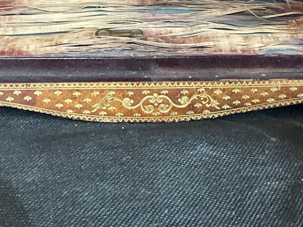 A miniature leather and gilt bound display cabinet. Circa 1880. View VI