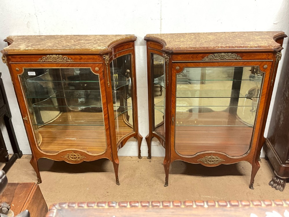 A pair of French marble topped kingwood display cabinets.
