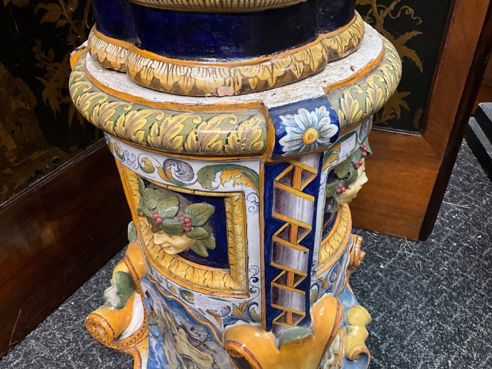 Large Italian Majolica tin-glazed earthenware vase with scrolled handles resting on an ornate matching pedestal base, decorated with painted mythological figures and relief masks. View VI