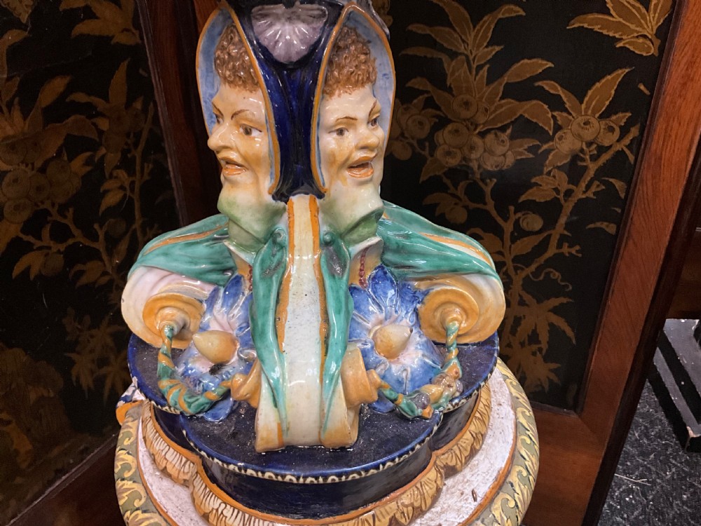 Large Italian Majolica tin-glazed earthenware vase with scrolled handles resting on an ornate matching pedestal base, decorated with painted mythological figures and relief masks. View VII
