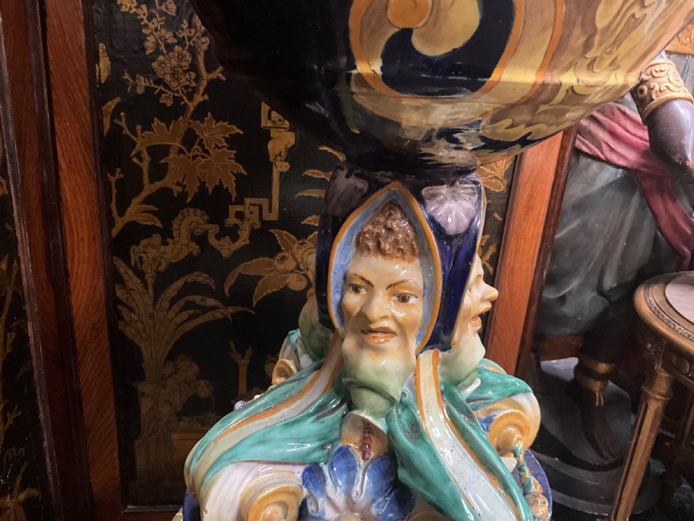 Large Italian Majolica tin-glazed earthenware vase with scrolled handles resting on an ornate matching pedestal base, decorated with painted mythological figures and relief masks. View X