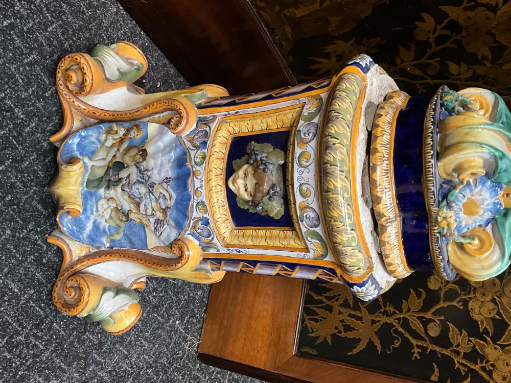 Large Italian Majolica tin-glazed earthenware vase with scrolled handles resting on an ornate matching pedestal base, decorated with painted mythological figures and relief masks. View XVIII