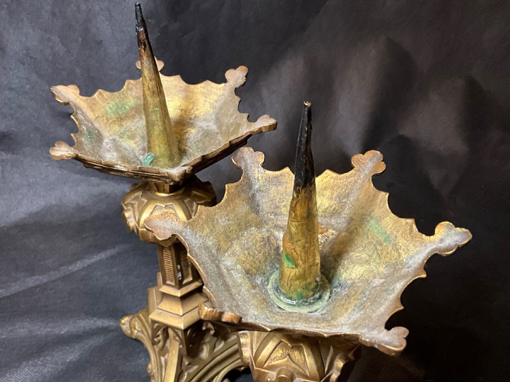 A pair of brass Gothic style candlesticks. View III