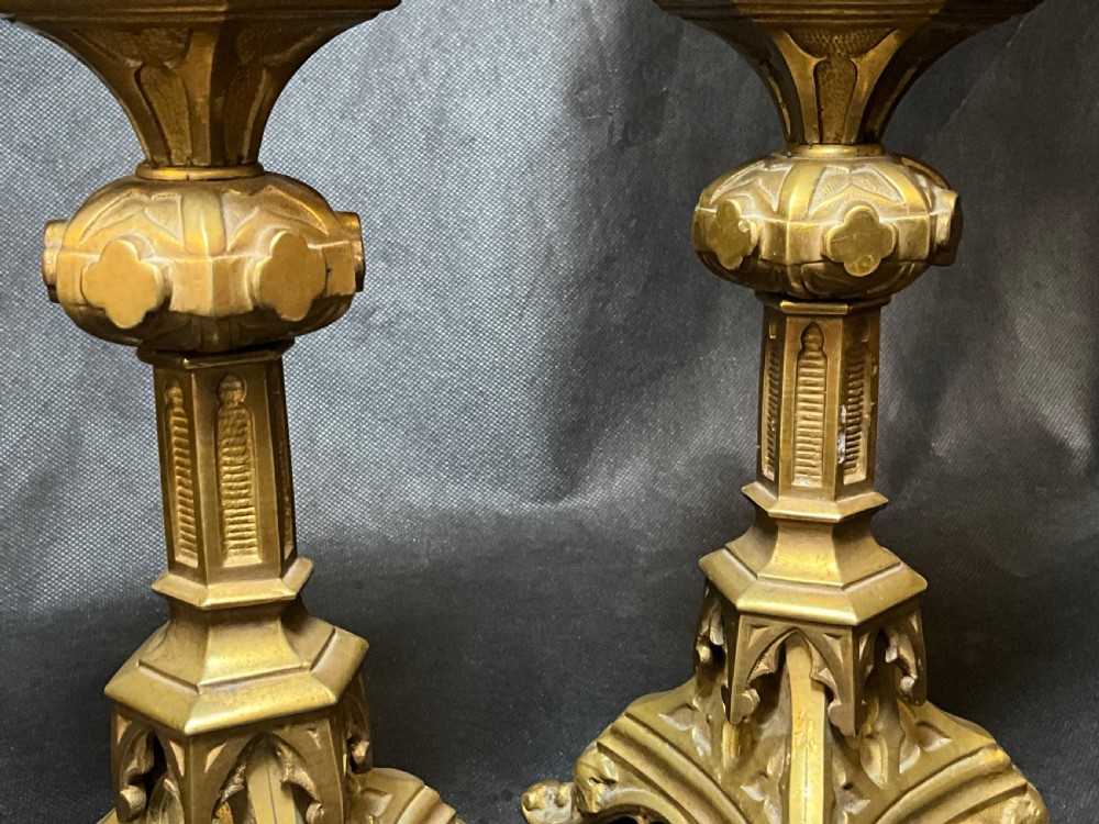 A pair of brass Gothic style candlesticks. View IV