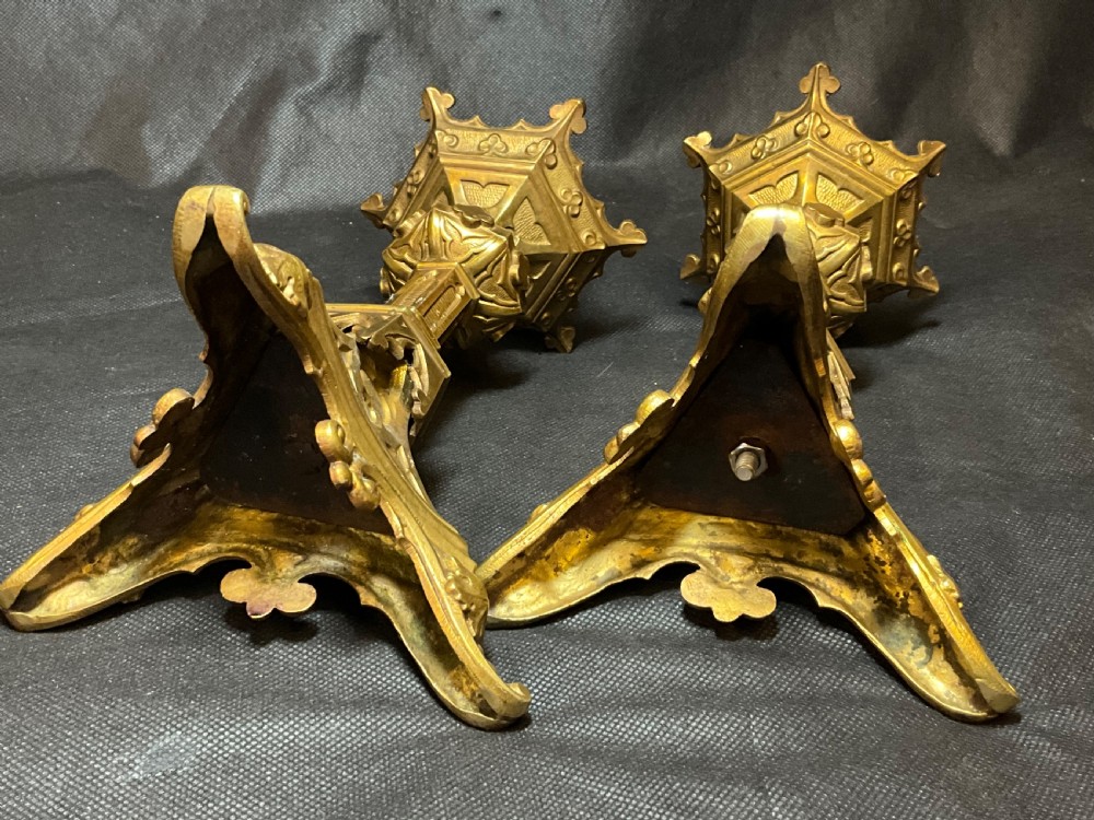 A pair of brass Gothic style candlesticks. View V