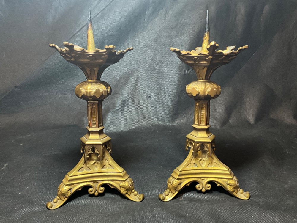 A pair of brass Gothic style candlesticks. View VII