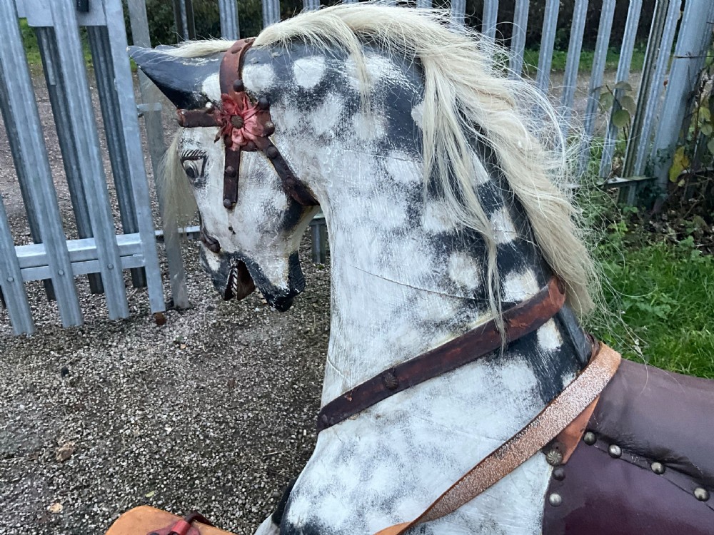 An antique carved wooden dapple grey rocking horse with real horsehair and leather tack mounted on a pine safety glider stand. View III