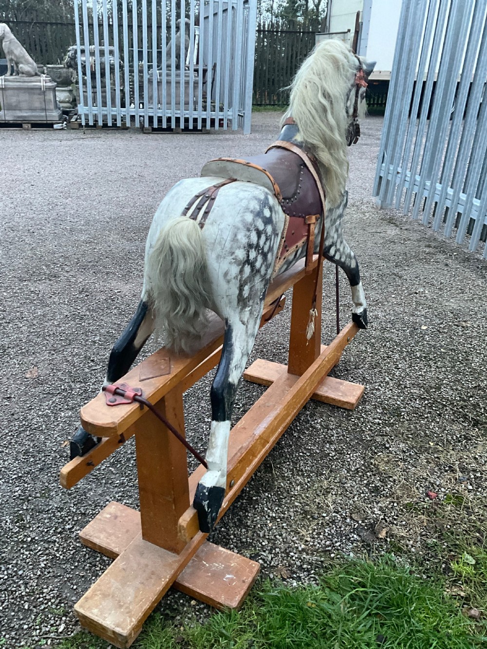 An antique carved wooden dapple grey rocking horse with real horsehair and leather tack mounted on a pine safety glider stand. View IV