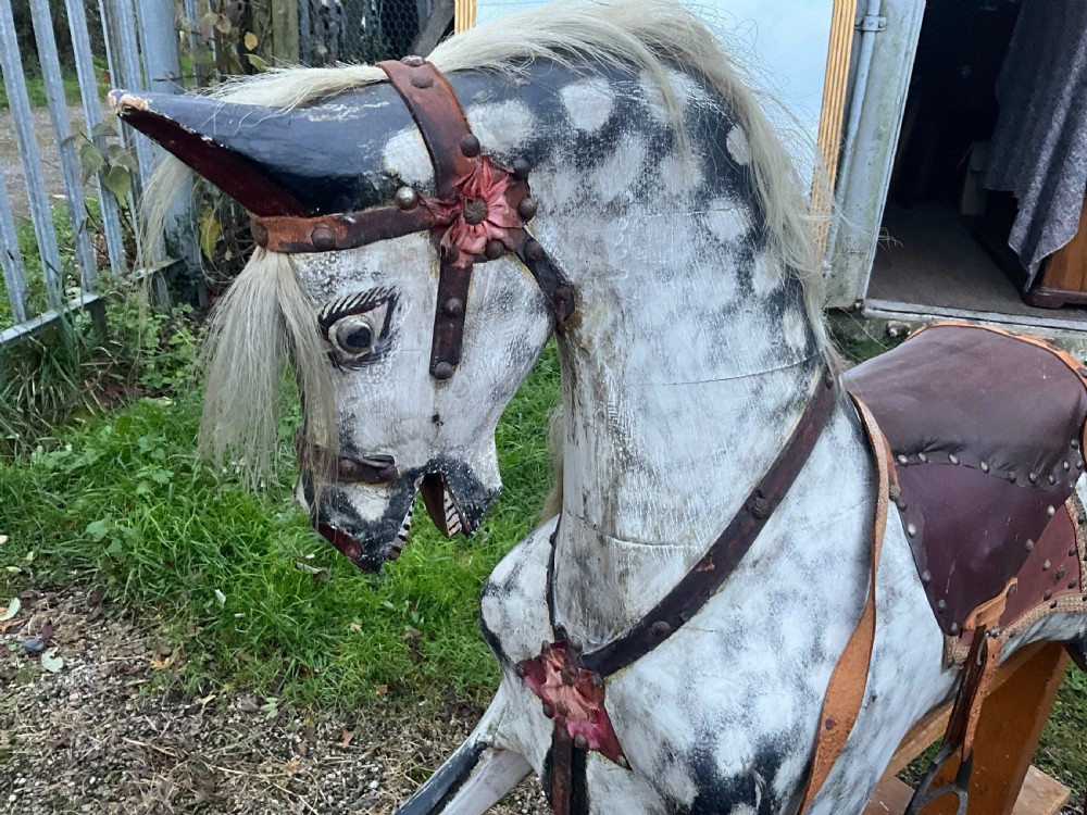 An antique carved wooden dapple grey rocking horse with real horsehair and leather tack mounted on a pine safety glider stand. View VII