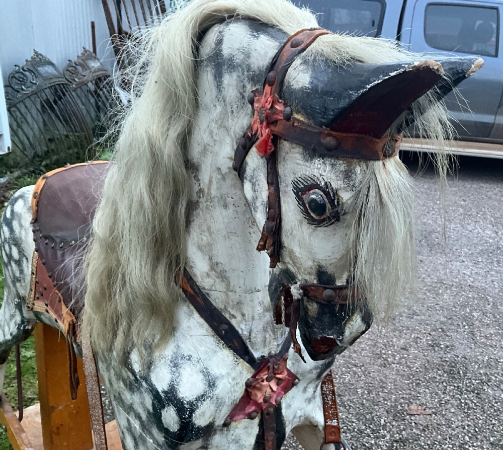 An antique carved wooden dapple grey rocking horse with real horsehair and leather tack mounted on a pine safety glider stand. View VIII