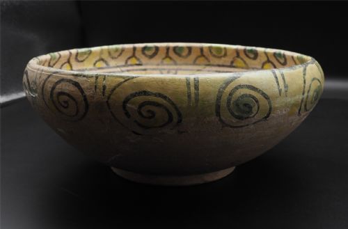 fig 1. A 10th-century Nishapur ceramic buffware bowl decorated with bold yellow glaze and dark brown geometric slip motifs.