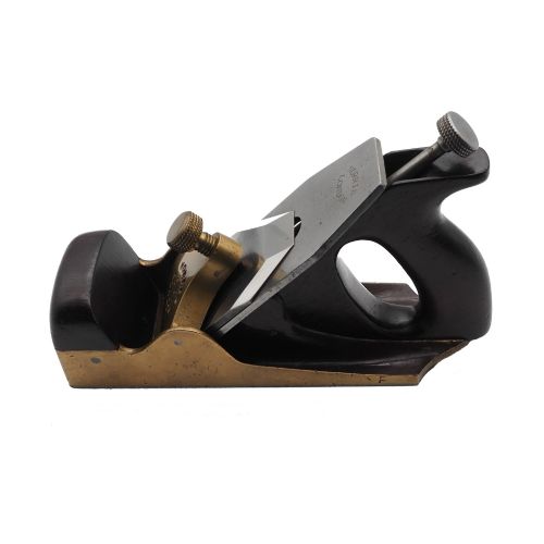 fig 1. An antique Norris London 51G smoothing plane featuring a gunmetal frame, dark hardwood infill, and adjustable steel cutter.